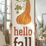 a person holding a sign that says hello fall