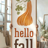 a person holding a sign that says hello fall