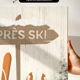 a hand holding up a sign with skis on it