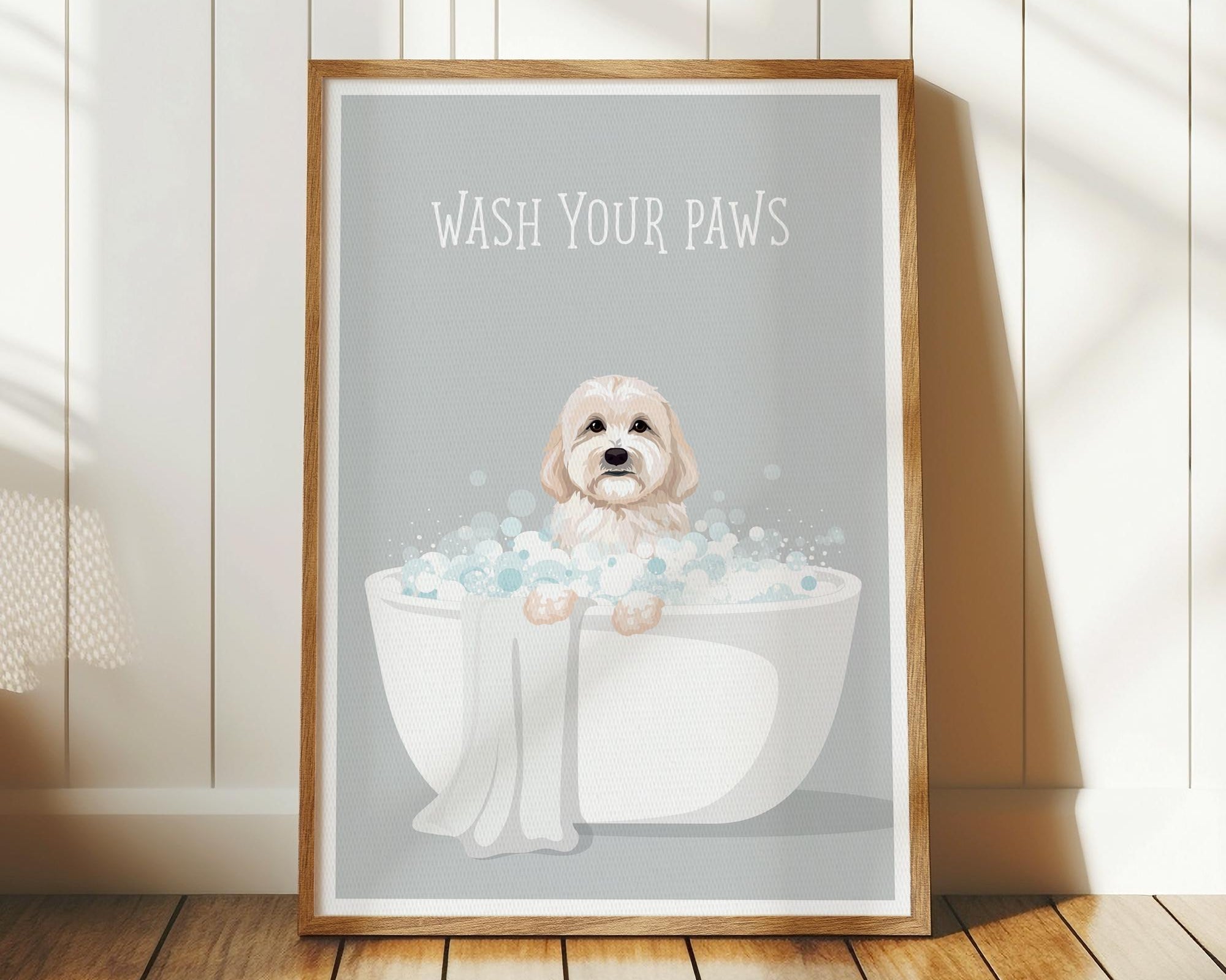 A framed poster with a cute dog sitting in a bathtub filled with bubbles, accompanied by the text "WASH YOUR PAWS".