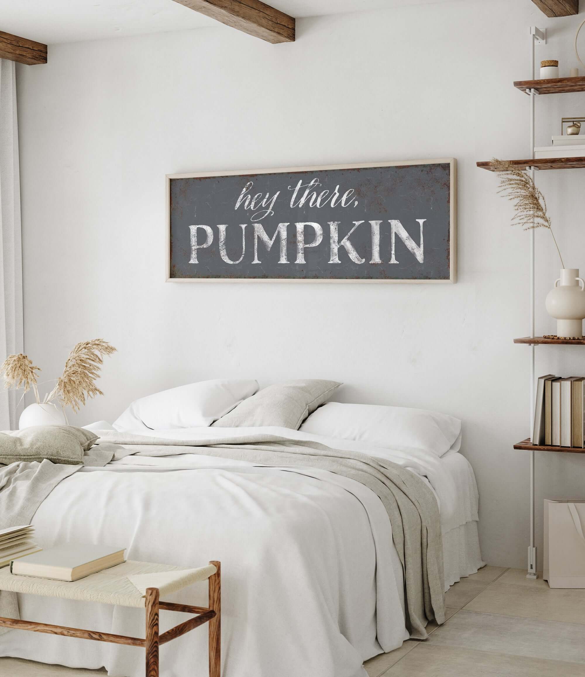 a bedroom with a bed and a wooden sign above it