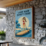 a framed poster with a woman paddleboarding on a lake, with the text "LAKESHAIR DON'T CARE" displayed prominently.