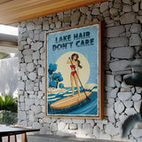 a framed poster with a woman paddleboarding on a lake, with the text "LAKESHAIR DON'T CARE" displayed prominently.