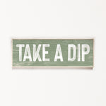 a wooden sign that says take a dip