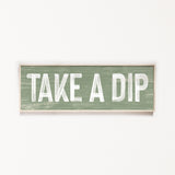 a wooden sign that says take a dip