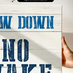 a hand holding a sign that says draw down no wake
