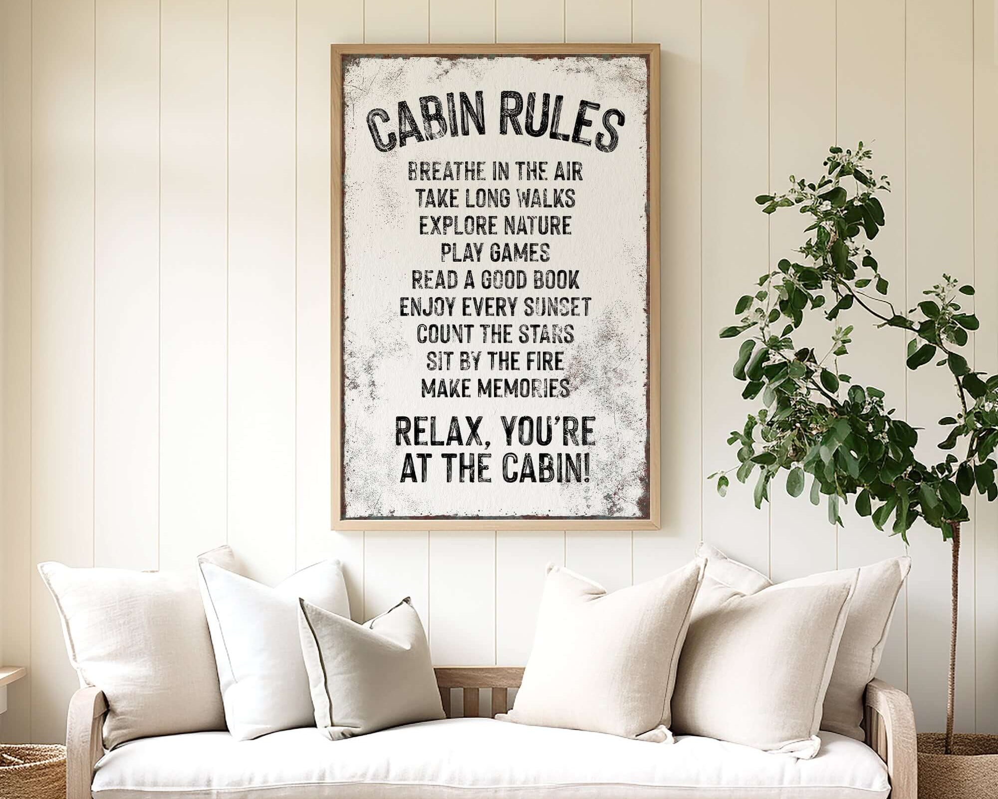 a living room with a couch and a poster on the wall