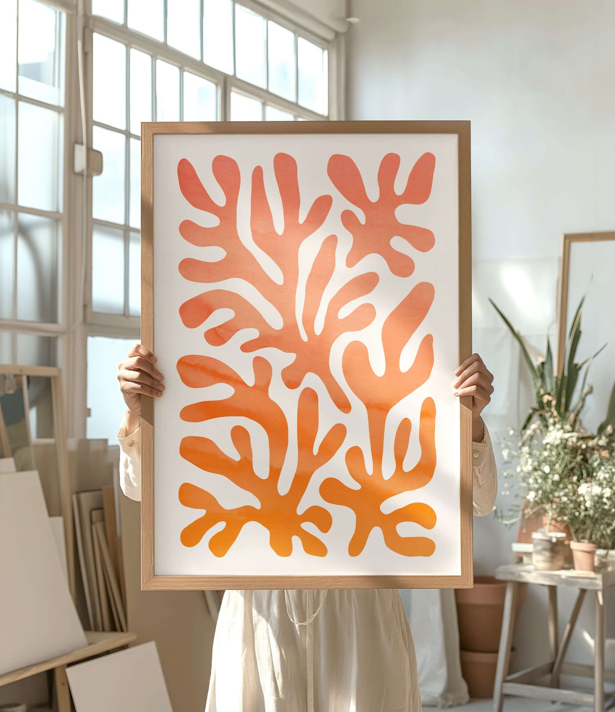 a person holding up a picture of a coral