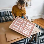 a woman holding a sign that reads let go and let go