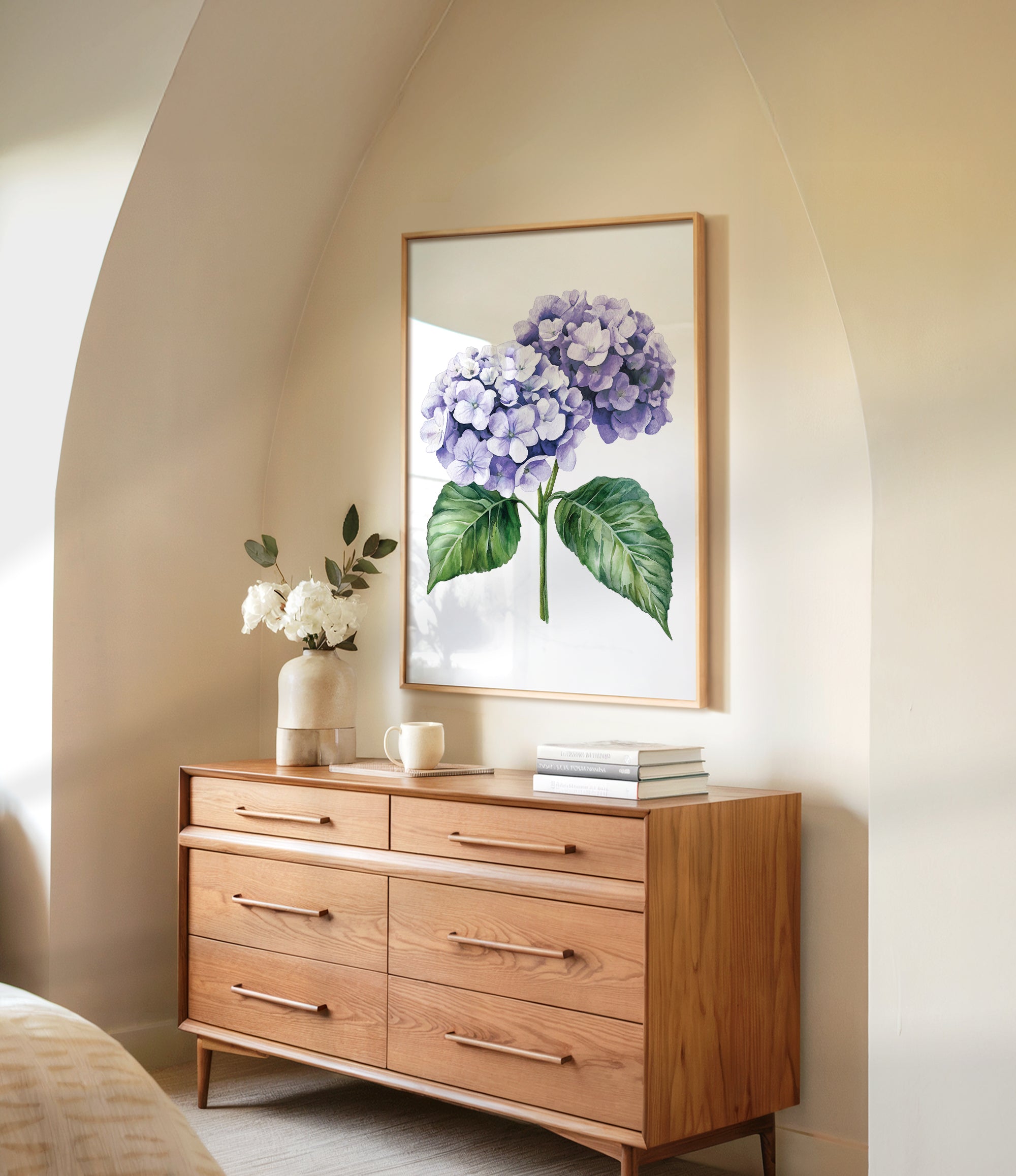 a wooden dresser with a framed picture of purple hydrangeas hanging on the wall above it. The dresser has six drawers and a vase of white flowers on top.