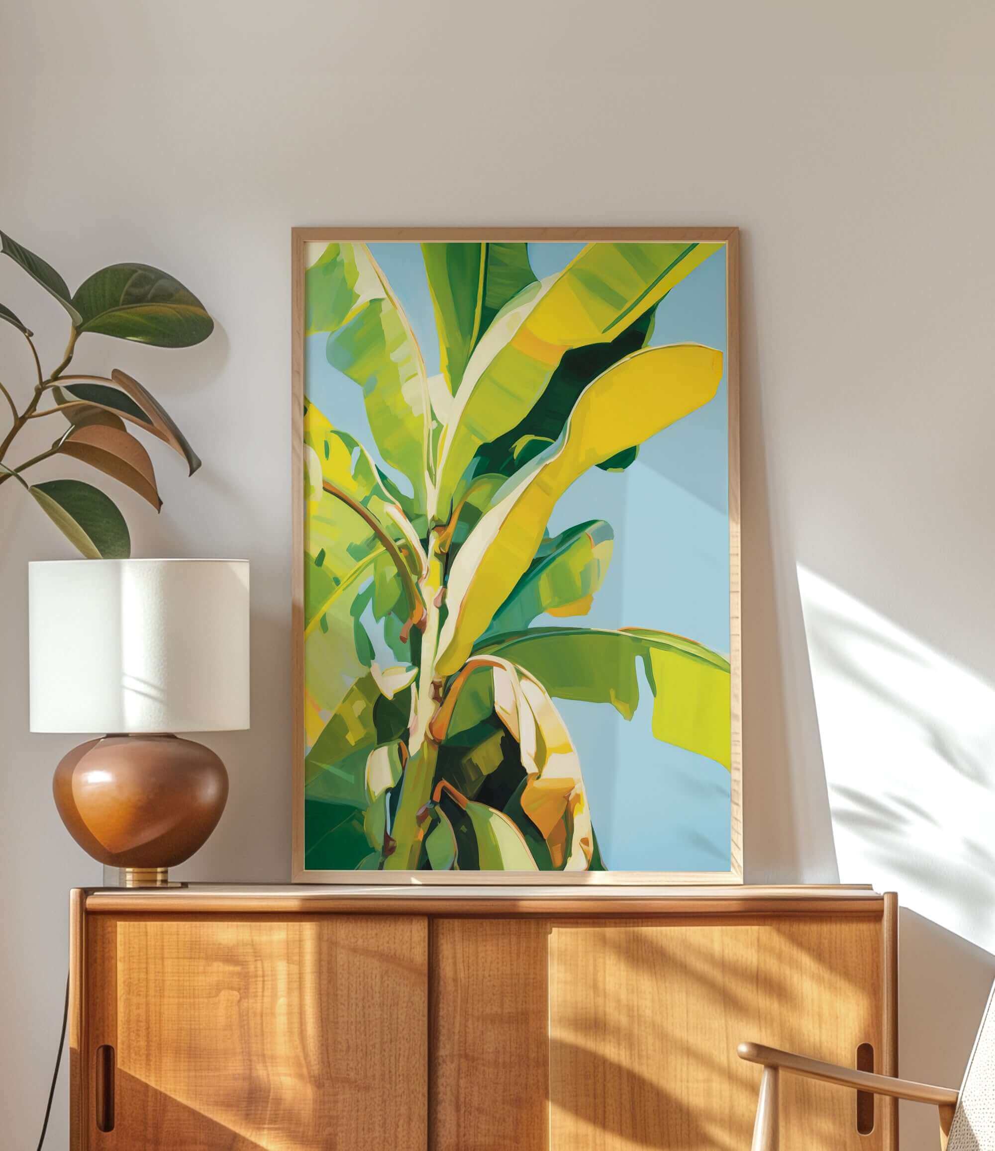 a large, vibrant painting of a banana tree hanging on a wall above a wooden cabinet.