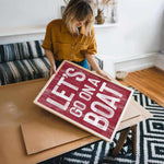 a woman holding a sign that says let&#39;s get out of bed