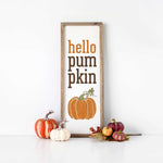 a sign that says hello pumpkin pumpkin next to some pumpkins