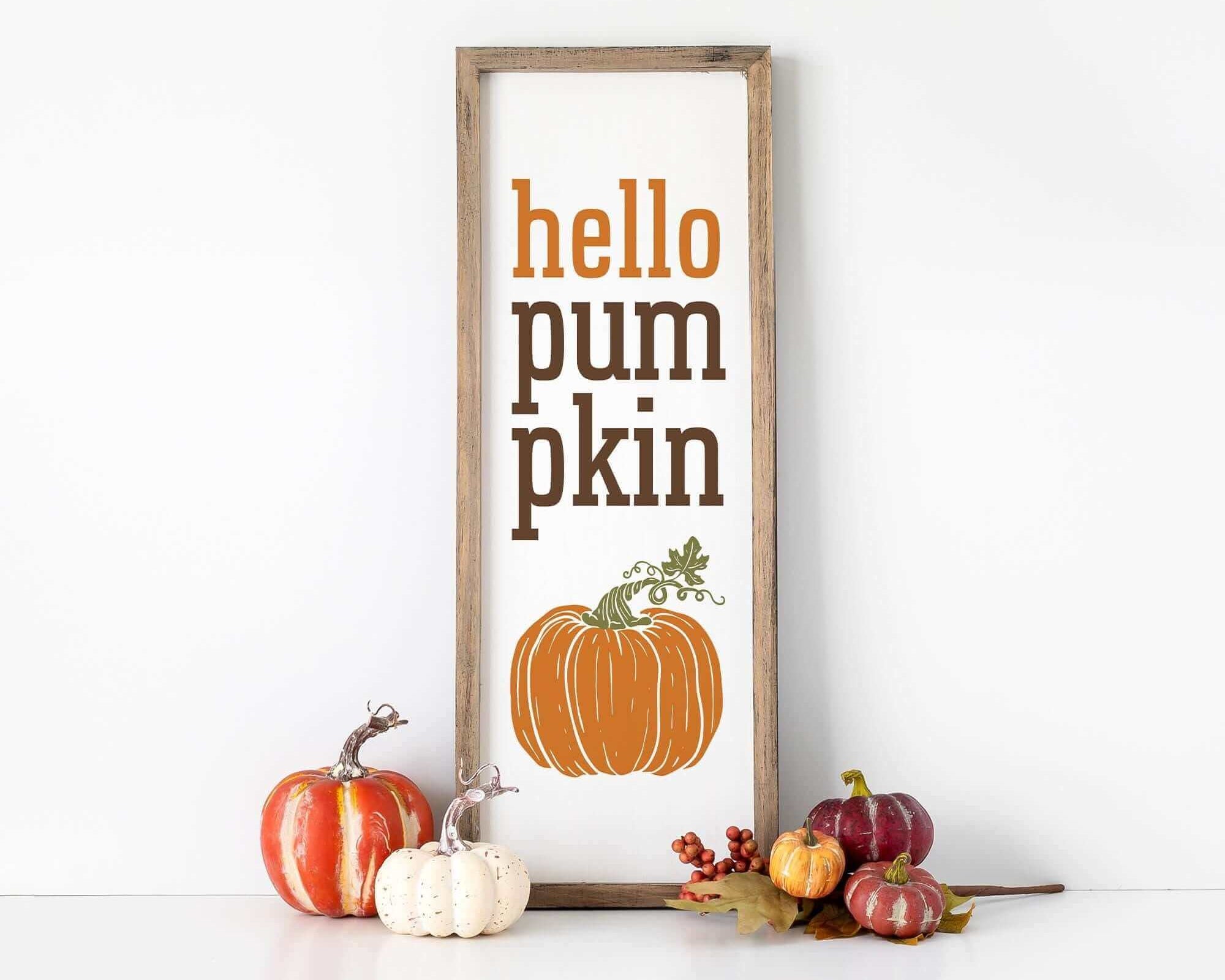 a sign that says hello pumpkin pumpkin next to some pumpkins