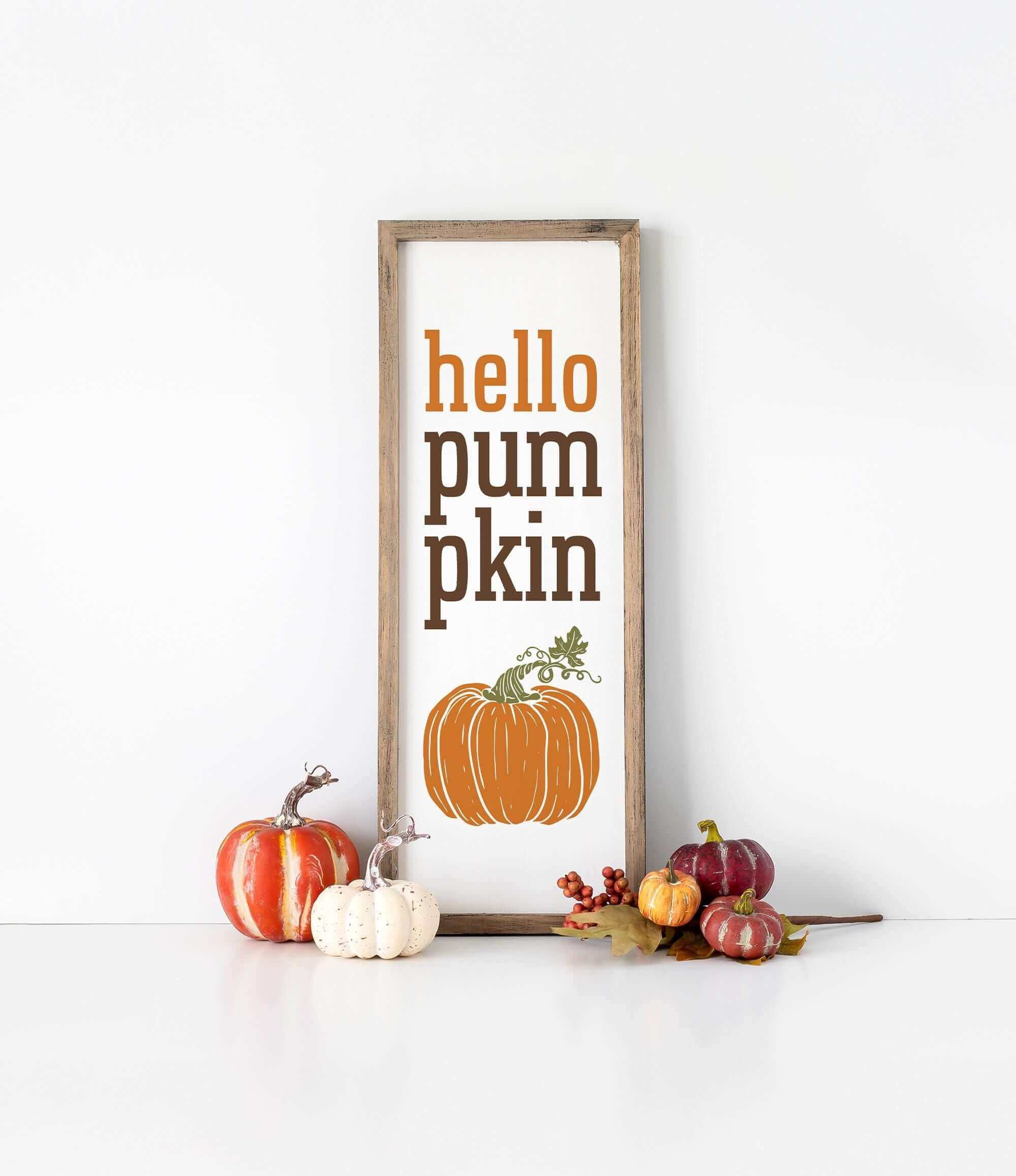 a sign that says hello pumpkin pumpkin next to some pumpkins