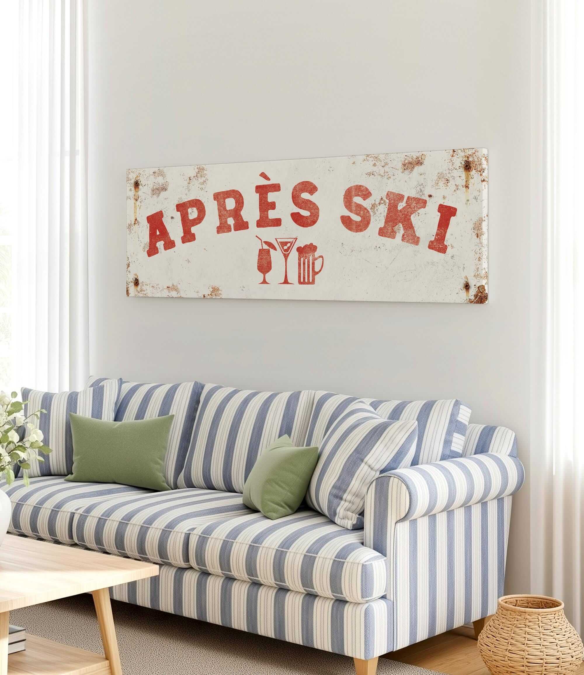 a living room with a striped couch, a coffee table, and a large sign that says "APRES SKI" above the couch.