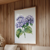 a large framed painting of purple hydrangeas hanging on a wooden wall.
