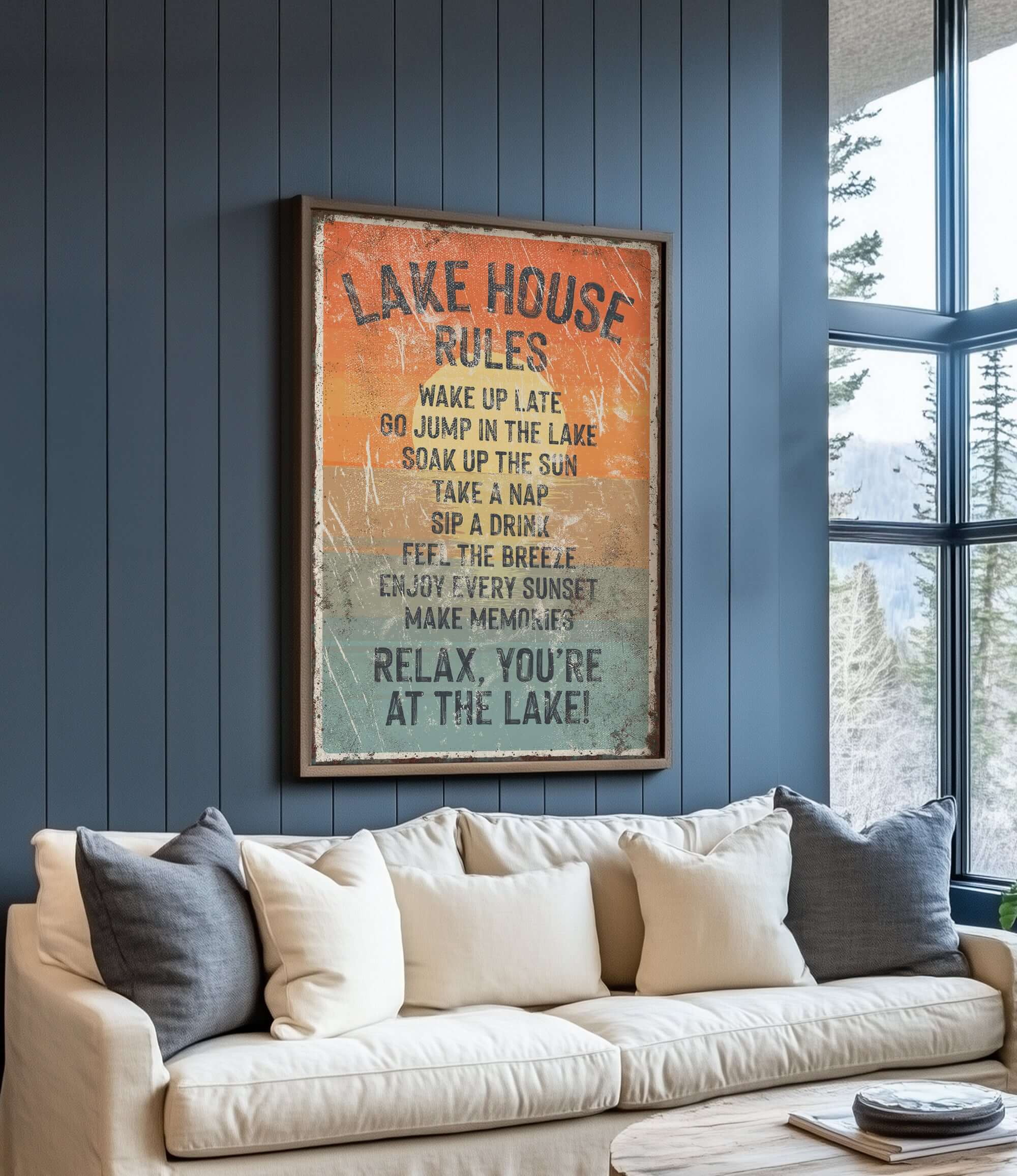 A framed sign on a wall that reads "LAKESHOUSE RULES" and lists various activities such as "WAKE UP LATE", "GO JUMP IN THE LAKE", "SOAK UP THE SUN", "TAKE A NAP", "DRINK", "FEEL THE BREEZE", "ENJOY EVERY SUNSET", and "MAKE MEMOJIES".