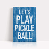 a blue sign that says let's play pickle ball