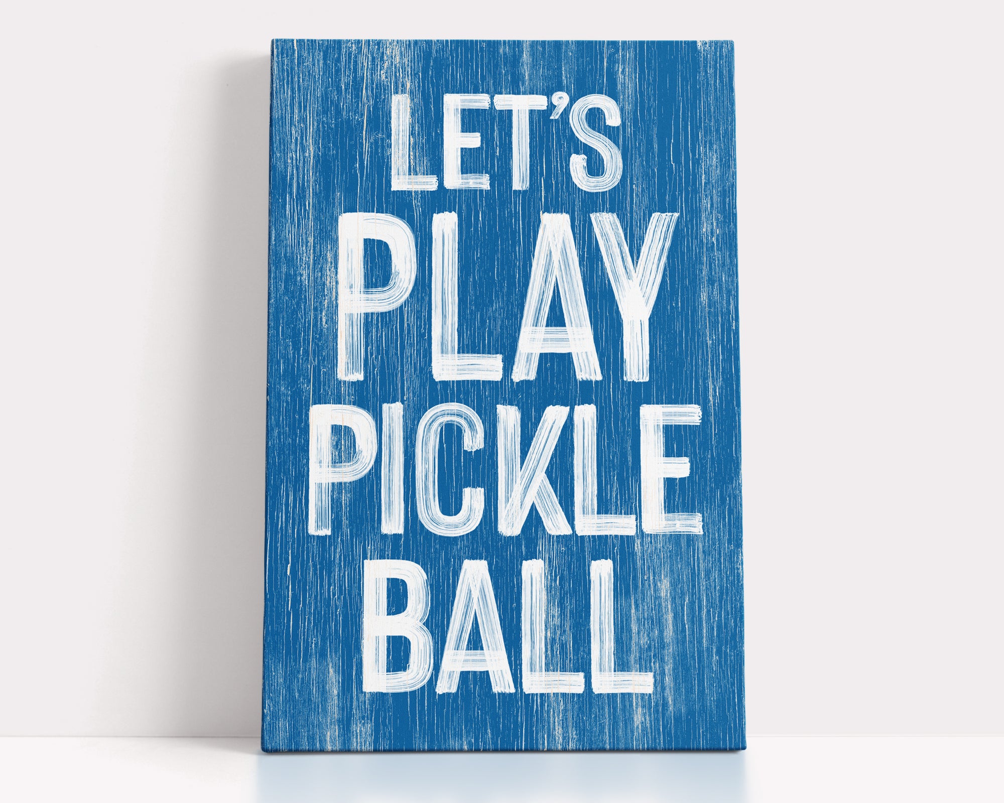 a blue sign that says let's play pickle ball