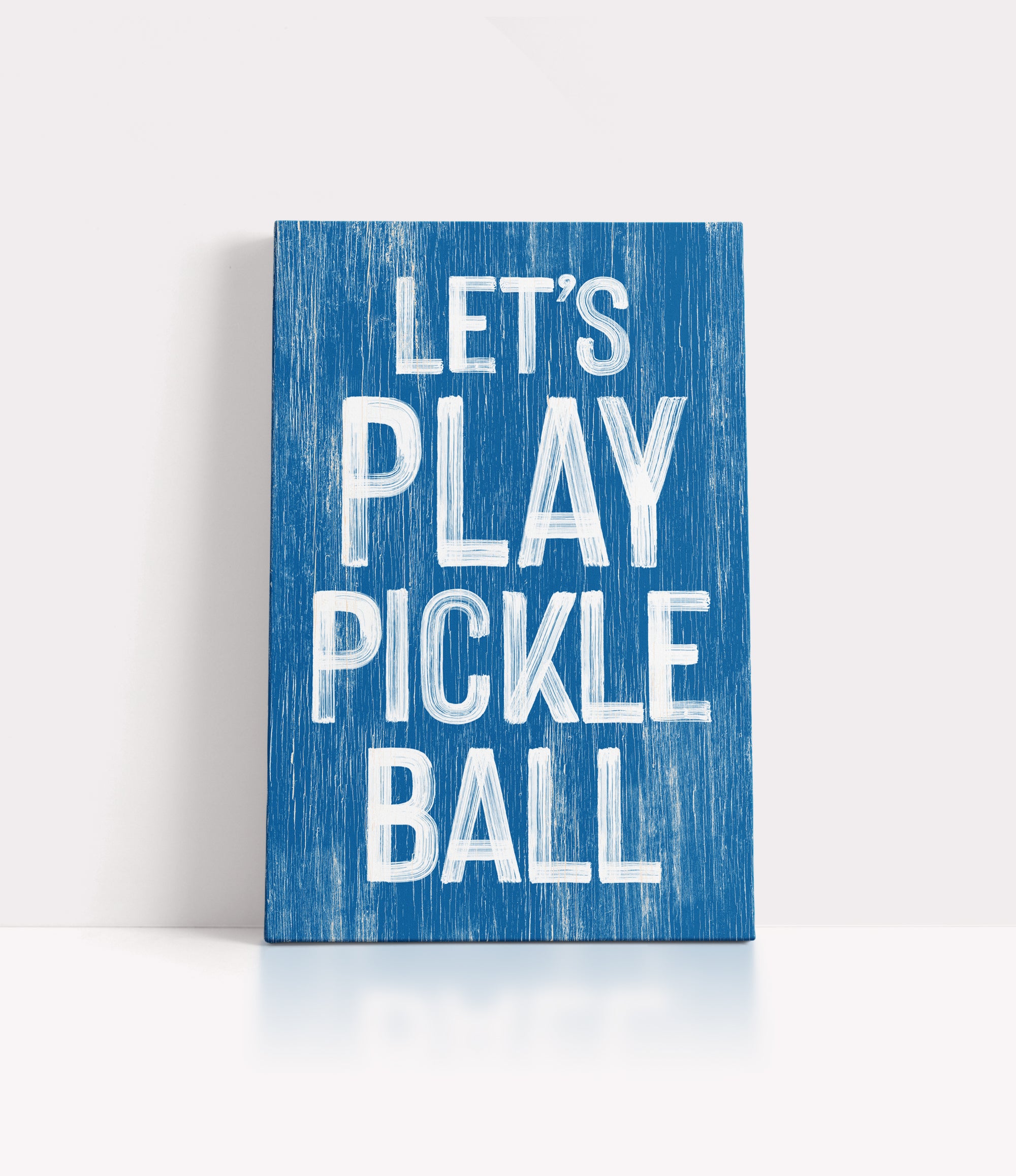 a blue sign that says let's play pickle ball