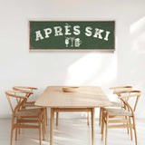 a wooden dining table with four chairs, and a large green sign with white text hanging above the table.