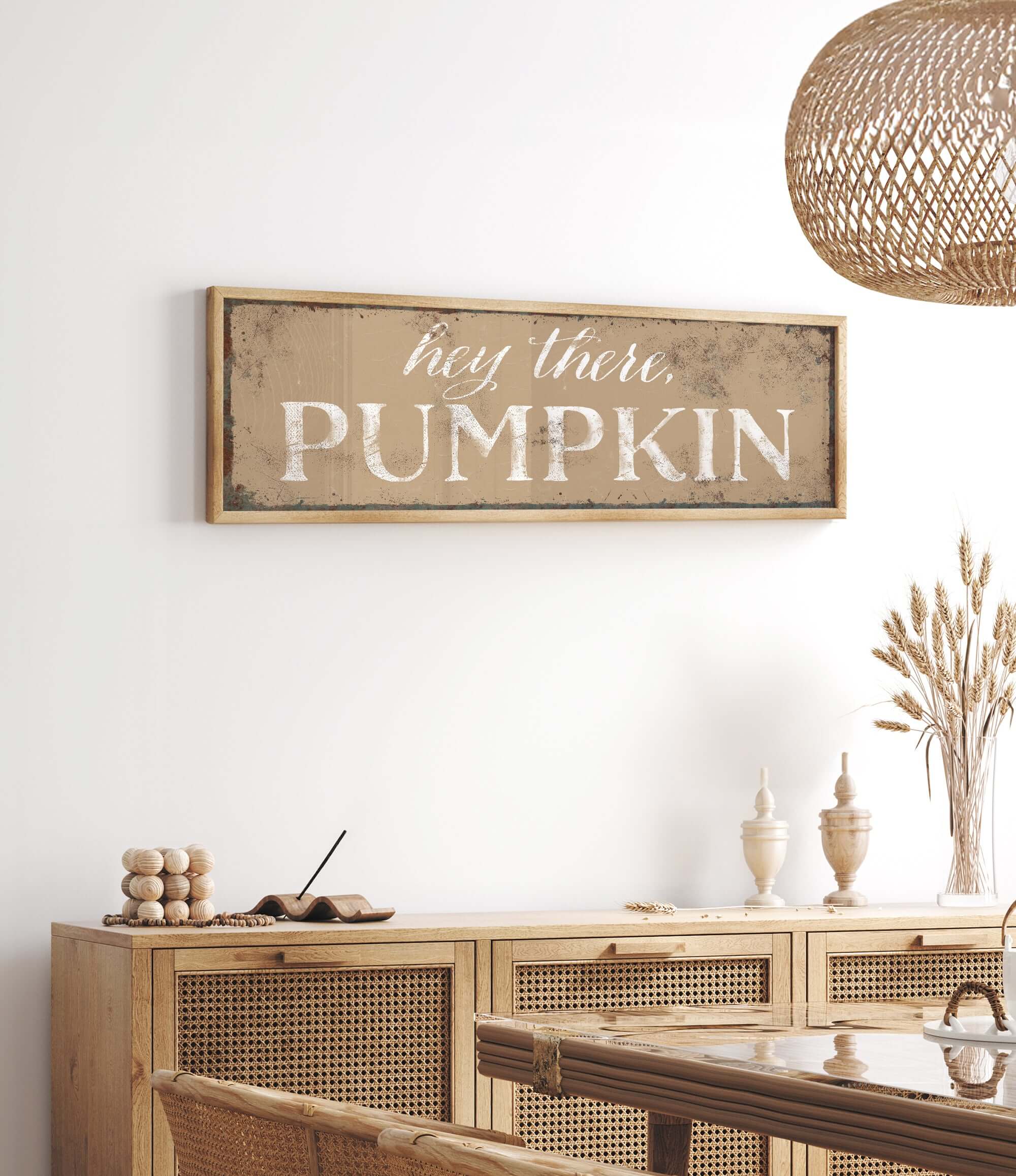 a white wall with a wooden sign that says hey there pumpkin