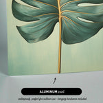 The image is an aluminum print featuring a close-up of a large green leaf with a gold stem.