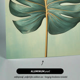The image is an aluminum print featuring a close-up of a large green leaf with a gold stem.