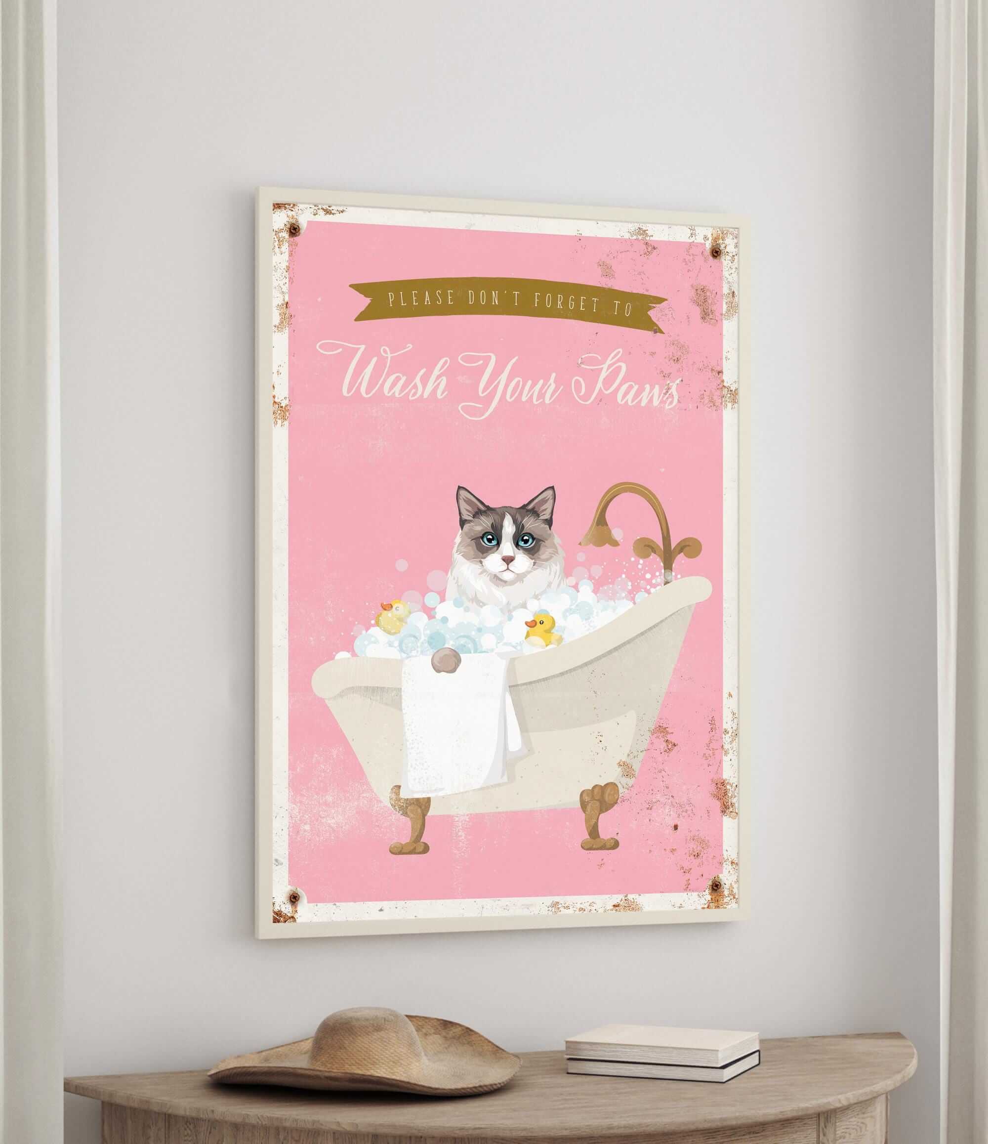 A framed poster with a cat sitting in a bathtub filled with bubbles, accompanied by the text "Please don't forget to wash your pans".