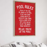a red poster hanging on a wall above a bed