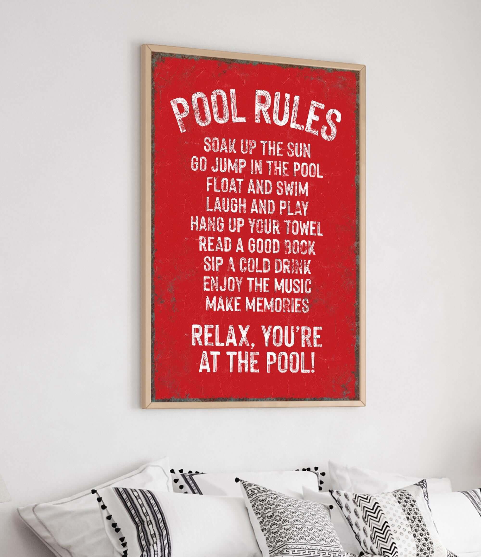 a red poster hanging on a wall above a bed