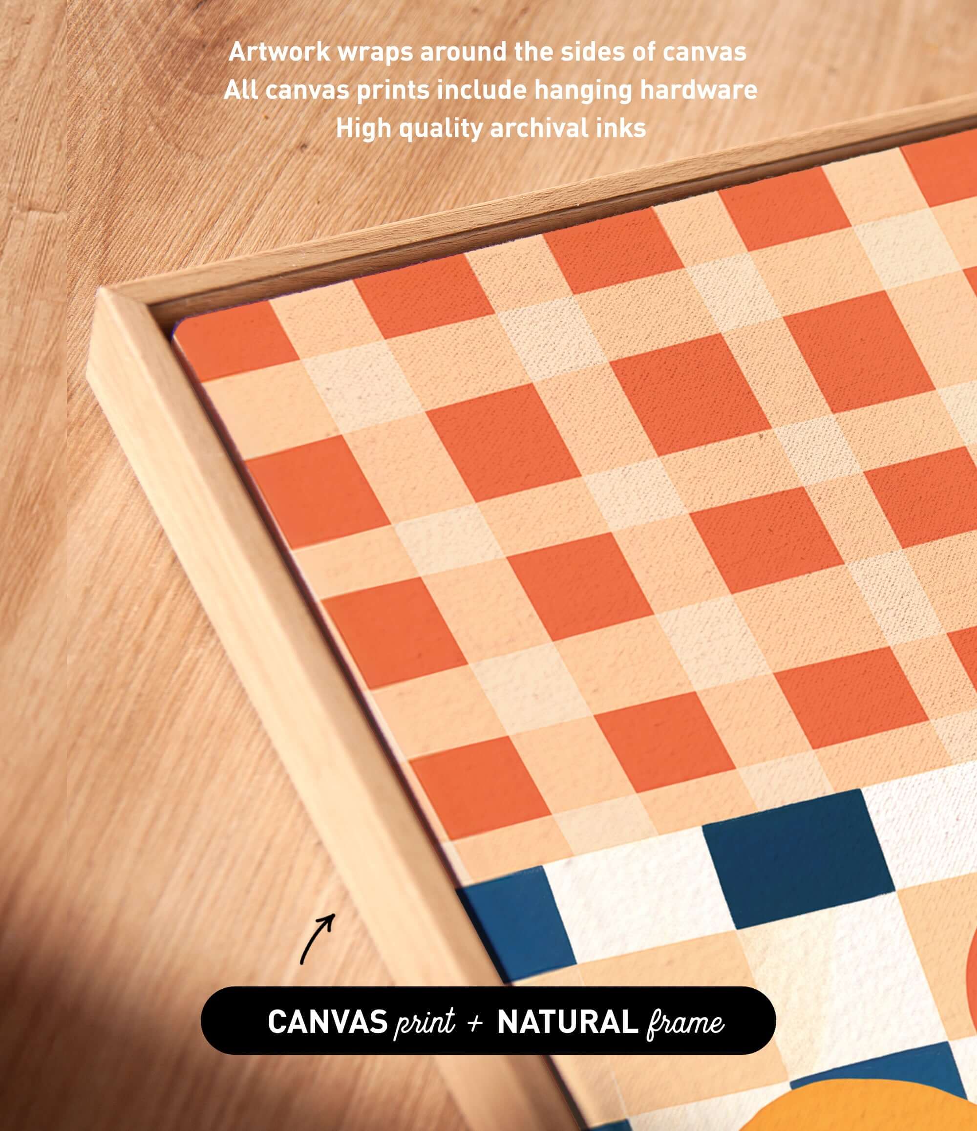 a close-up view of a wooden surface with a canvas print and a natural frame. The canvas print has a checkered pattern in shades of orange and white, and the natural frame complements the print. The text above the image states that artwork wraps around the sides of the canvas, and all canvas prints include hanging hardware. The text below the image indicates that the print is a "CANVAS print + NATURAL frame".