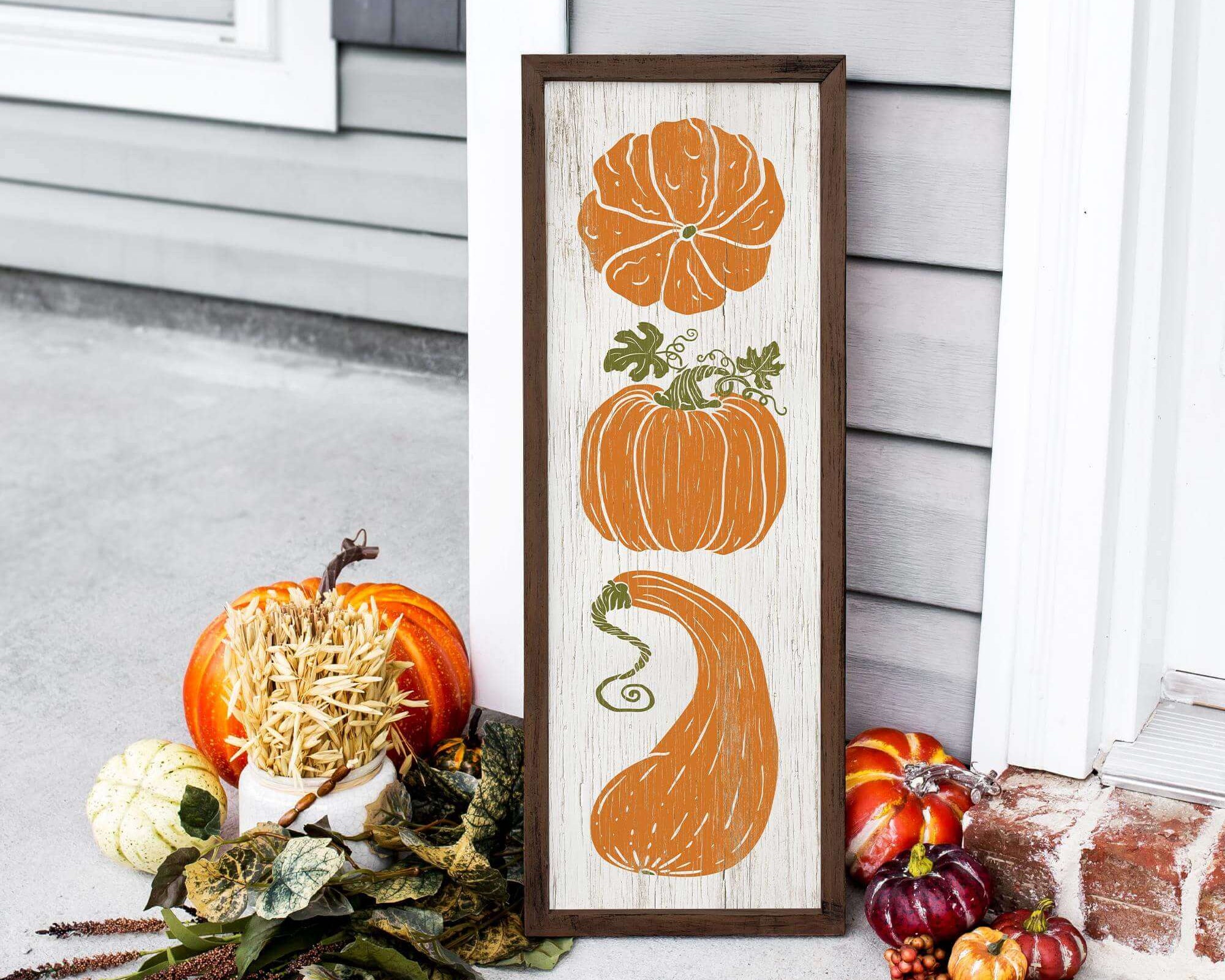 a picture of pumpkins and gourds on a porch