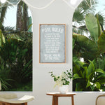 a room with a potted plant and a sign on the wall