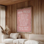 a living room with a white couch and a pink poster