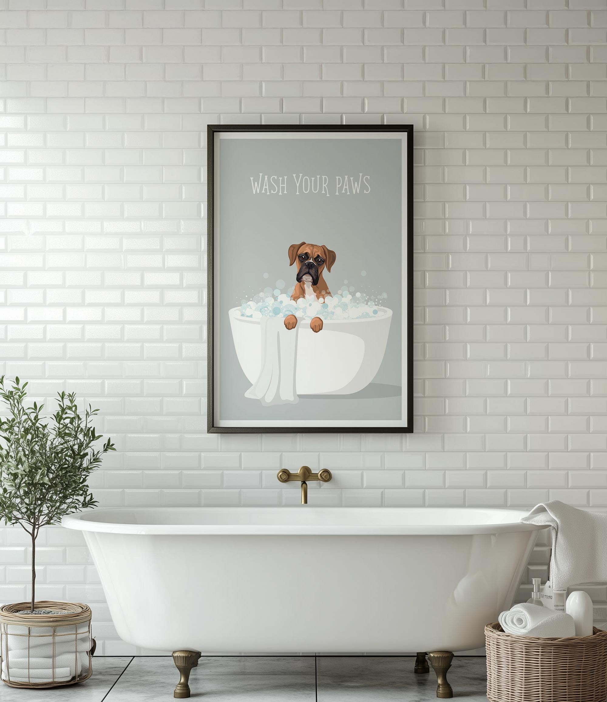A framed poster with a cartoon image of a dog sitting in a bathtub, accompanied by the text "WASH YOUR PAWS" is displayed on a white tiled wall above a white clawfoot bathtub.