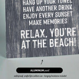 a textured background with a message encouraging relaxation and enjoyment at the beach.