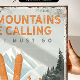 a person holding up a sign that says mountains are calling