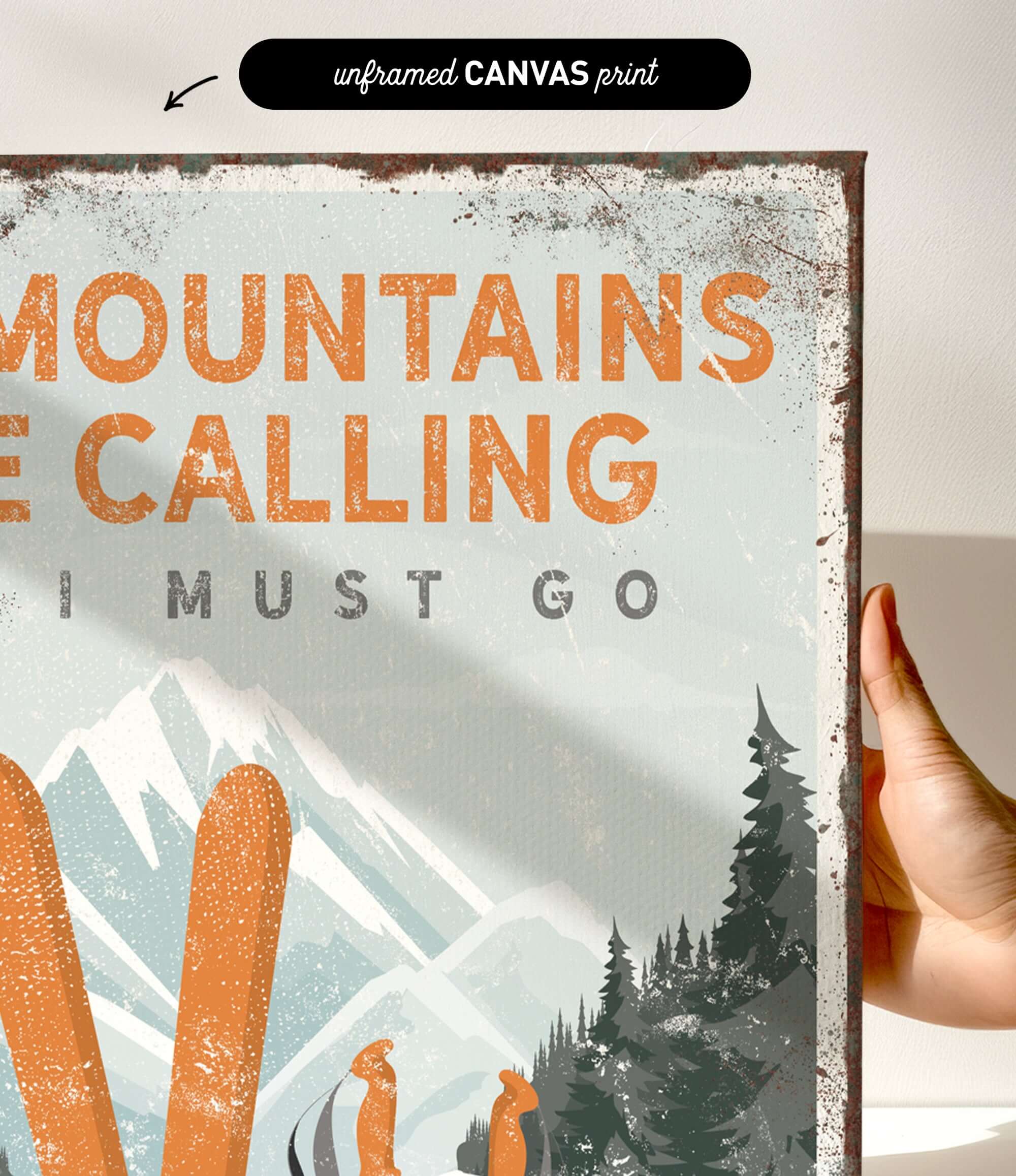 a person holding up a sign that says mountains are calling