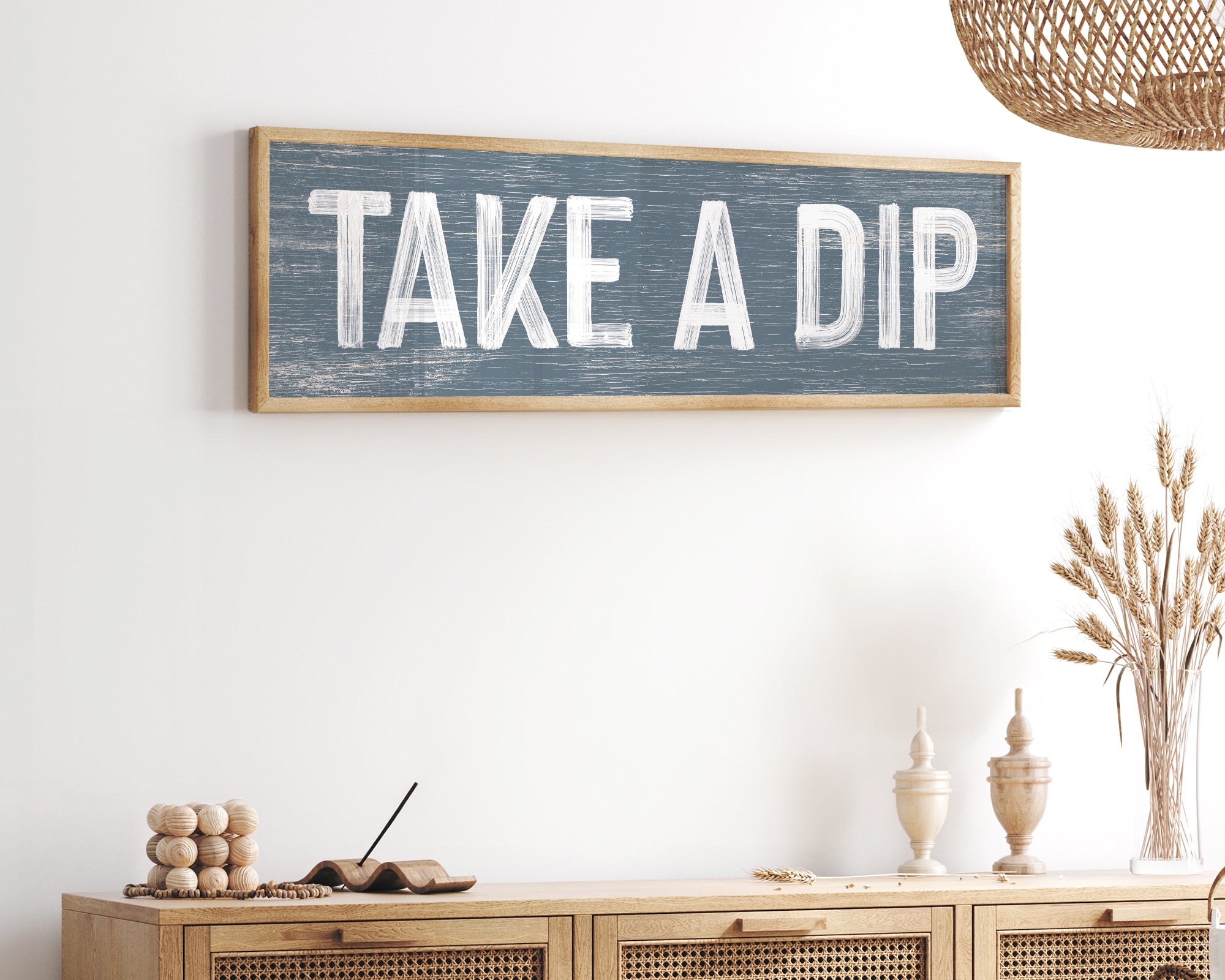 a wooden sign that says take a dip