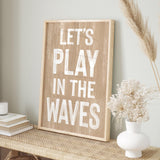a wooden sign that says let&#39;s play in the waves