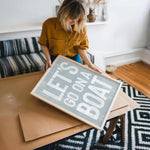 a woman holding a sign that says let&#39;s do what you want