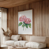 a cozy living room with a large floral painting hanging on the wall, featuring a vibrant pink hydrangea flower. The room is furnished with a sofa and a coffee table, creating a comfortable and inviting atmosphere.
