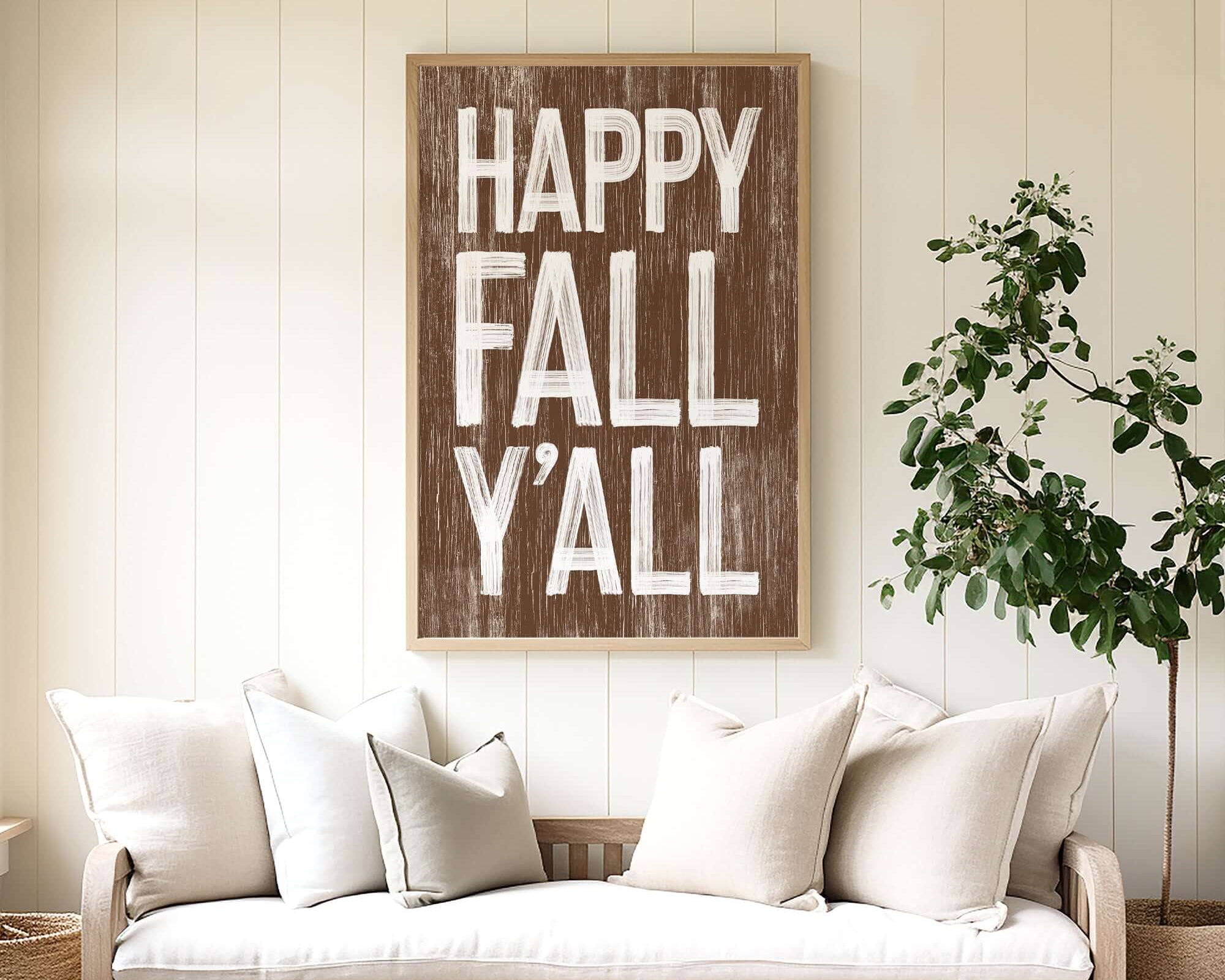 a living room with a couch and a happy fall y'all sign