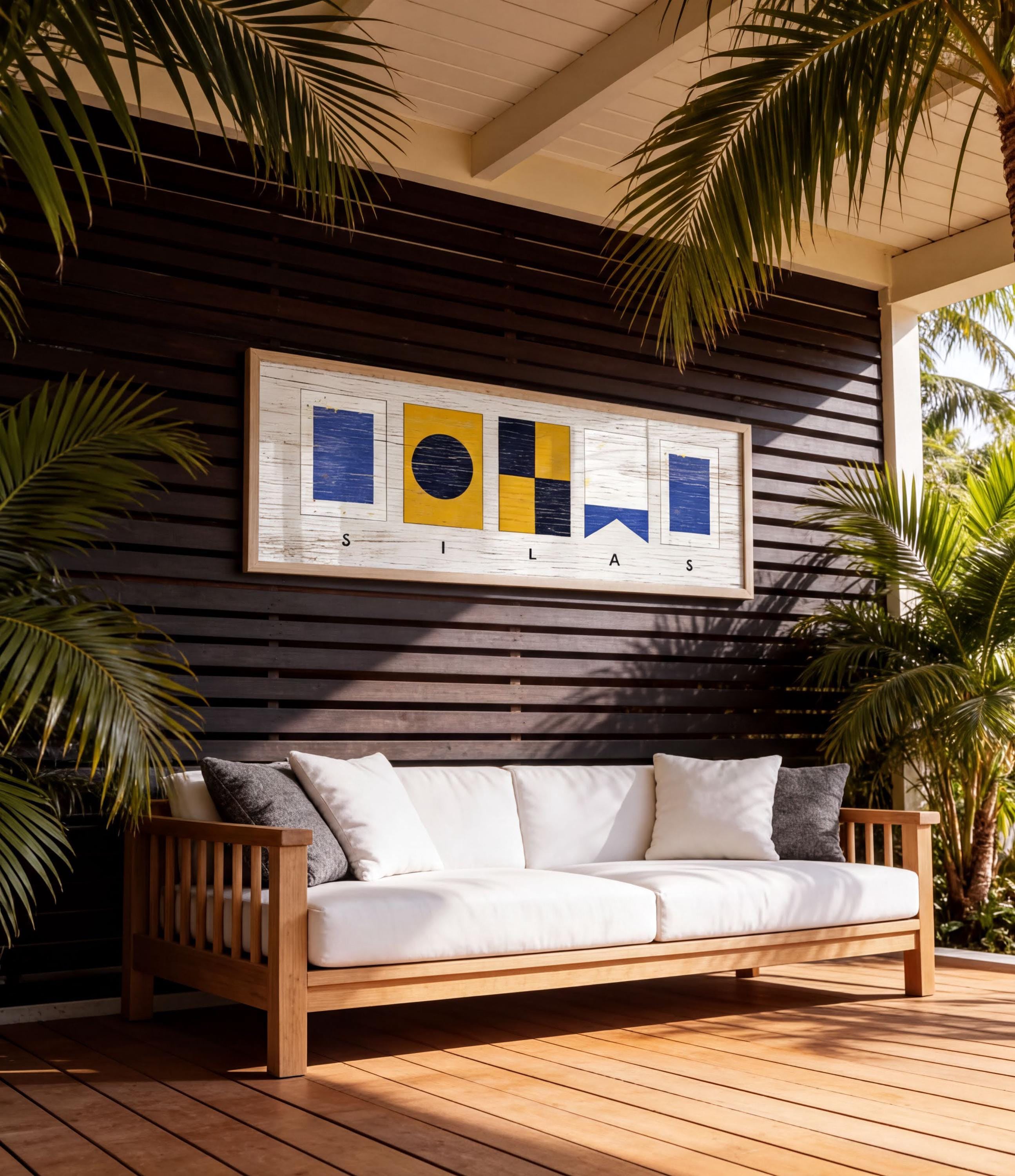 a wooden deck with a white sofa and a framed artwork hanging on the wall above it.