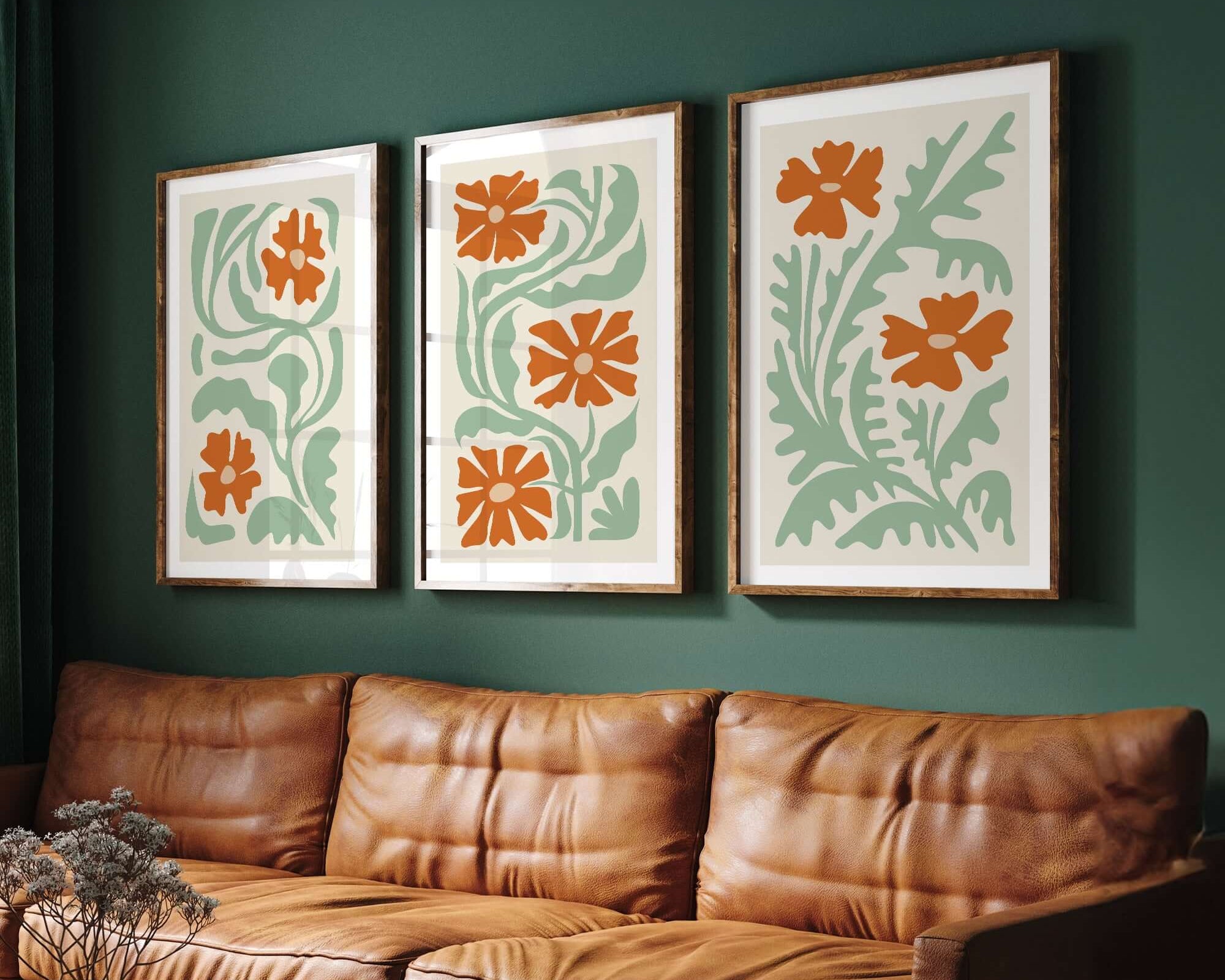 A brown leather couch sits beneath the Flower Blocks Triptych | Set of Three Prints | 013, adding elegant wall art to the dark green wall and elevating your home decor.
