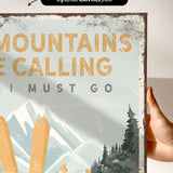 a hand holding a sign that says mountains are calling