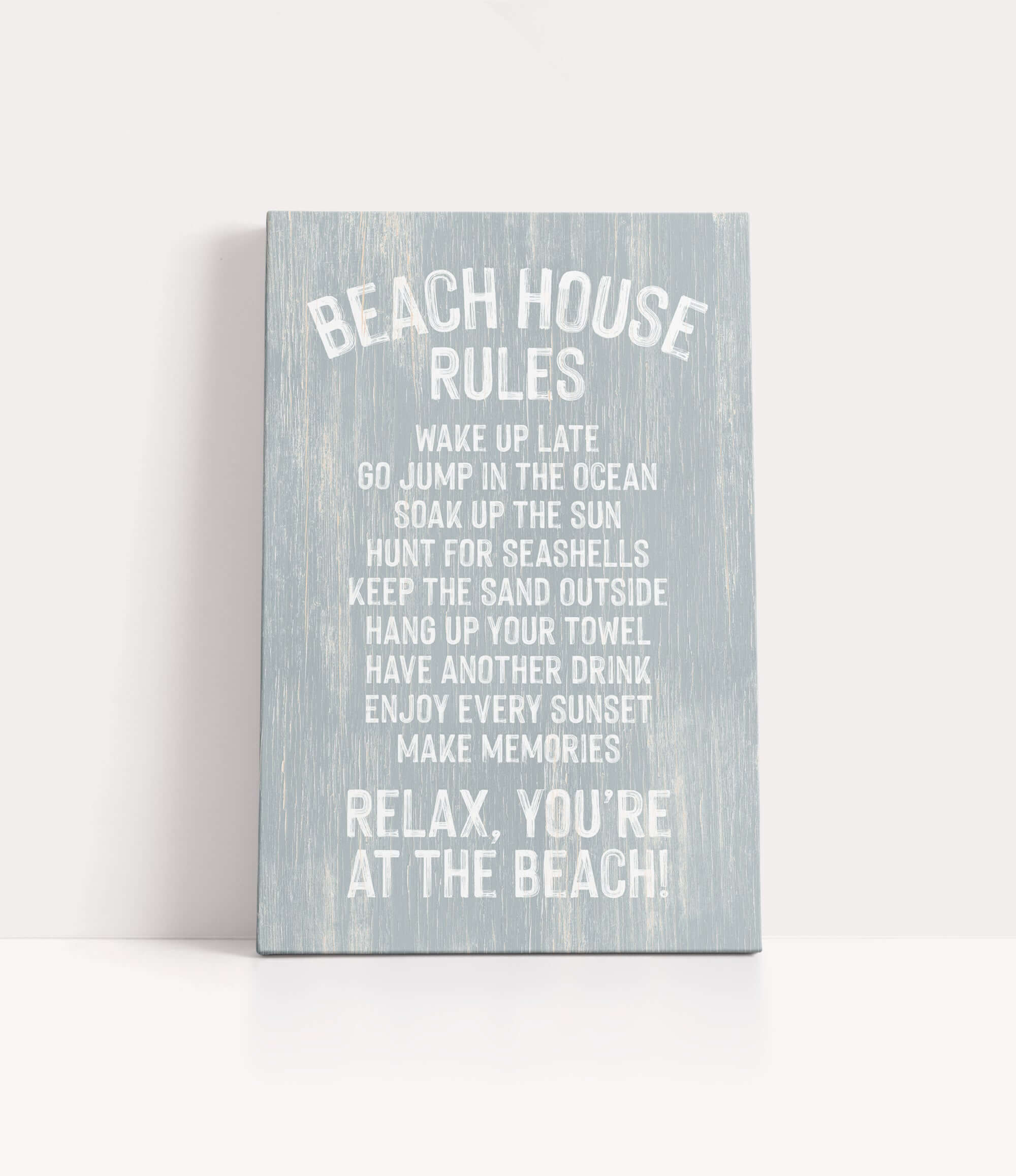 a sign with a list of beach house rules written in white text on a light blue background.