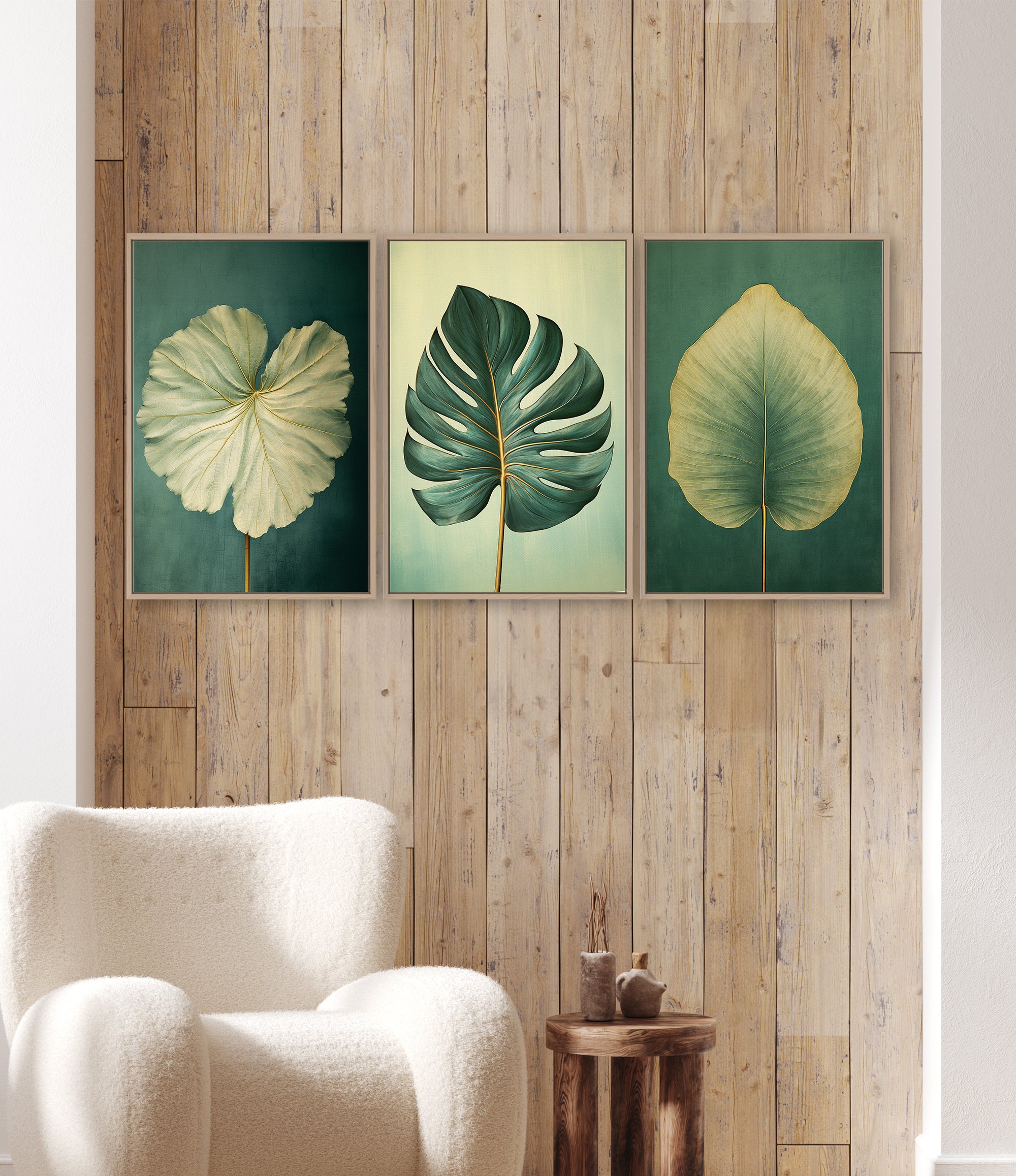 three framed paintings of tropical leaves hanging on a wooden wall.